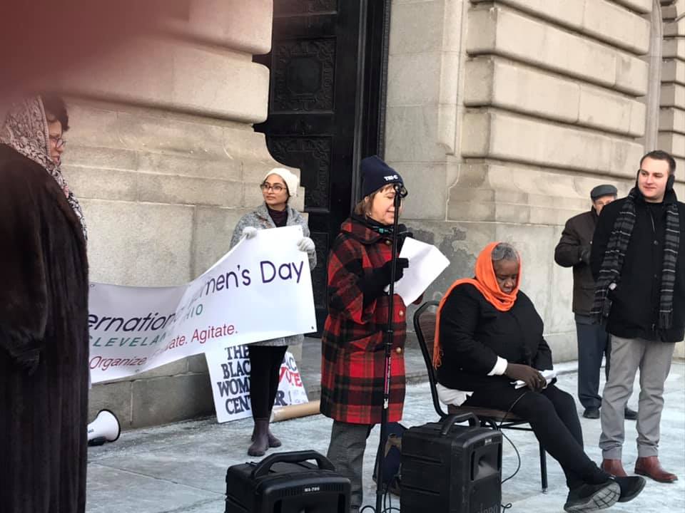 Photo of Kim Lenahan giving a speech on the steps of Cleveland City Hall by Kim Lenahan for International Women's Day 2019.